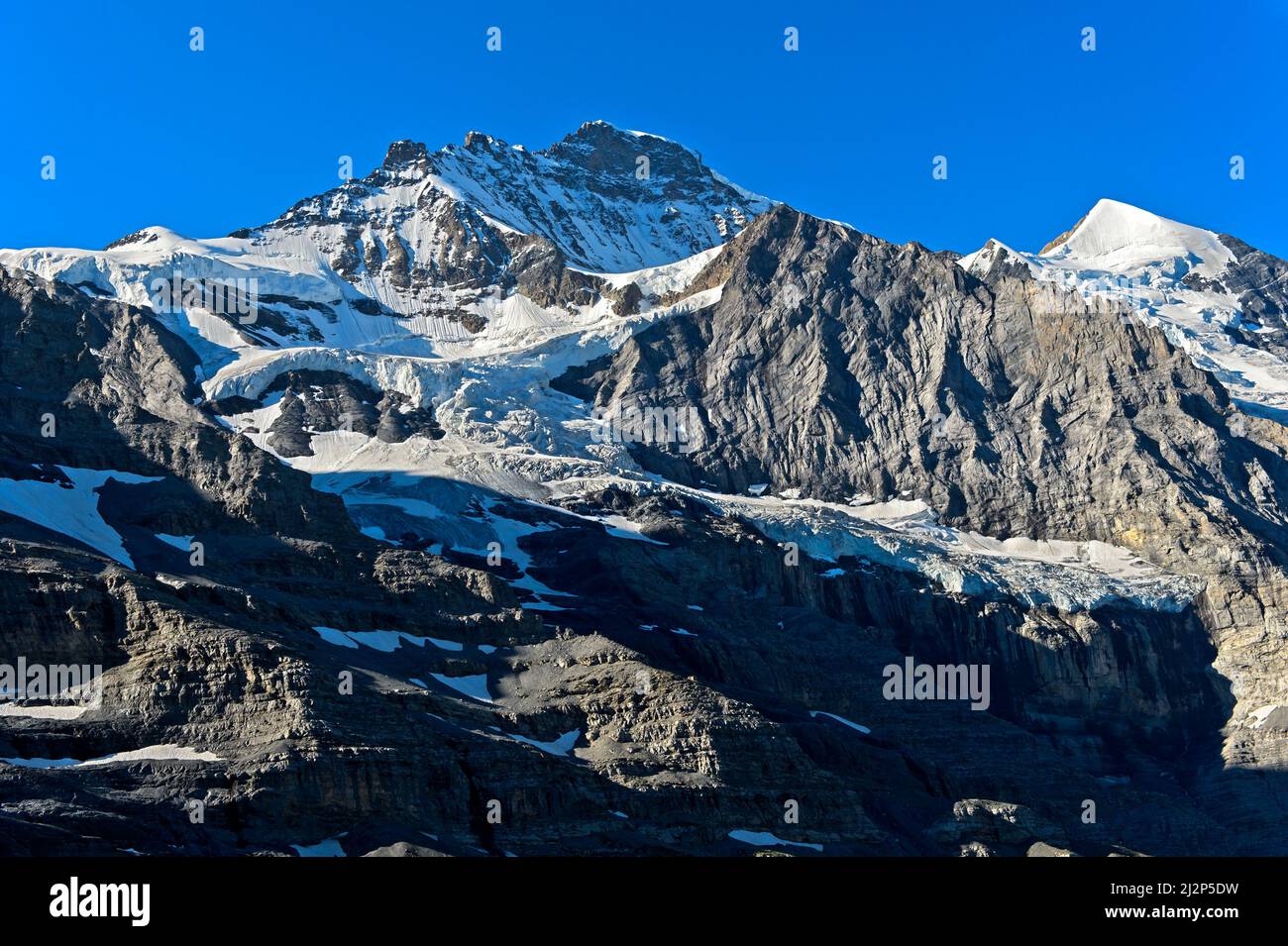 The summits of Jungfrau and, to the right, Silberhorn, Grindelwald, Bernese Oberland, Switzerland Stock Photo