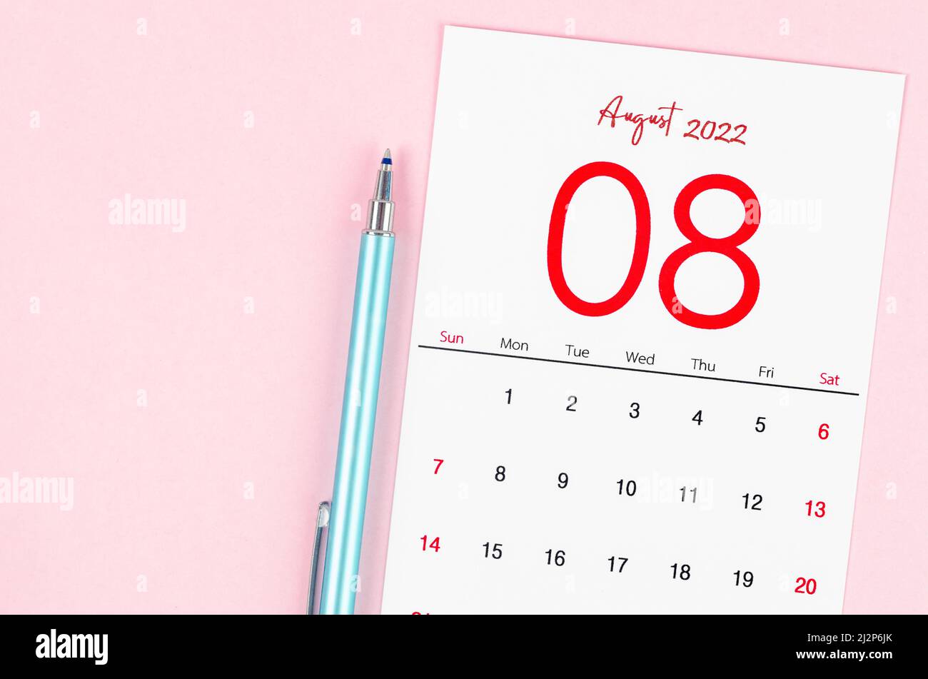 The August 2022 calendar with pen on pink background. Stock Photo