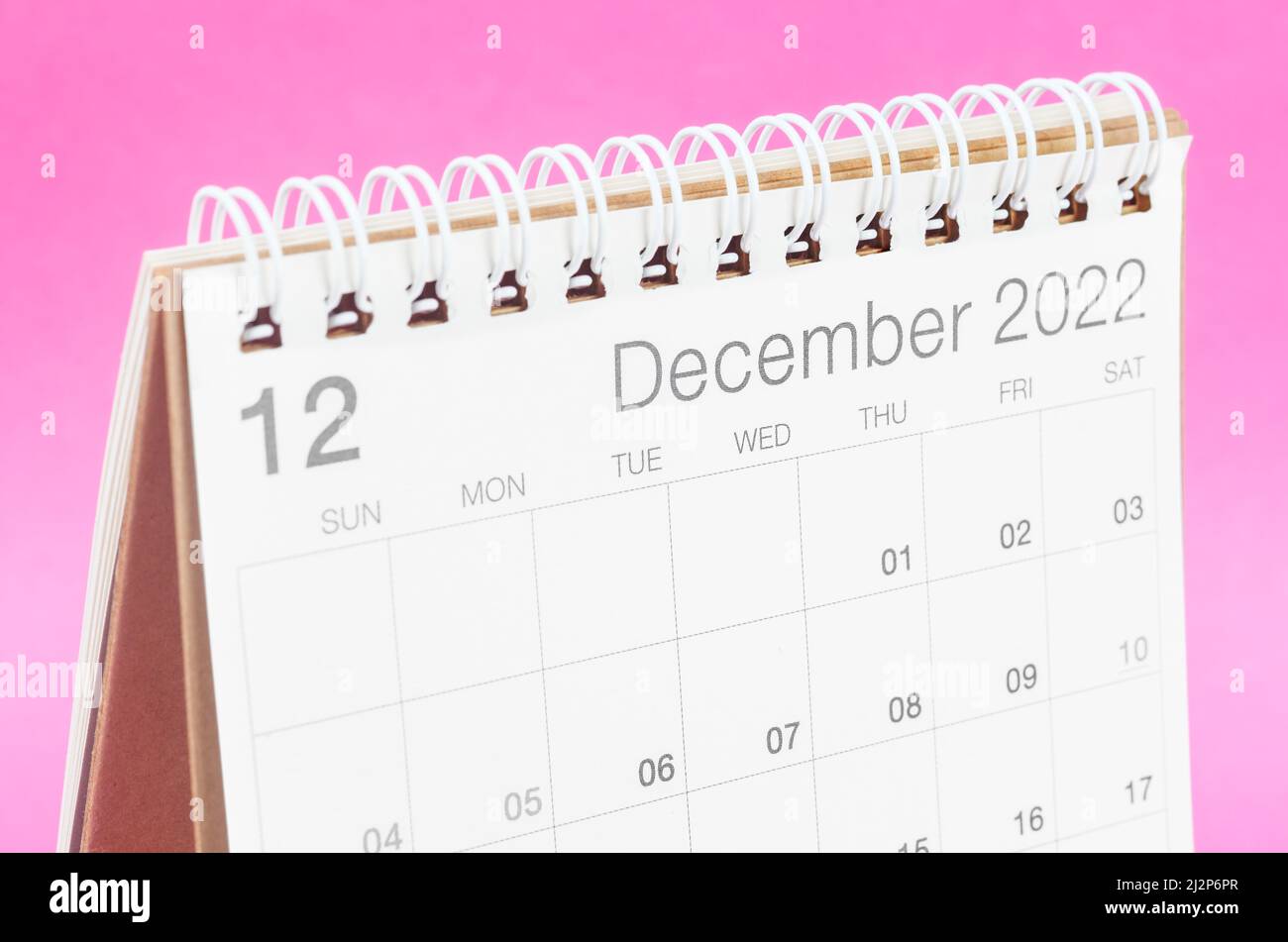 The December 2022 desk calendar on pink background with empty space. Stock Photo