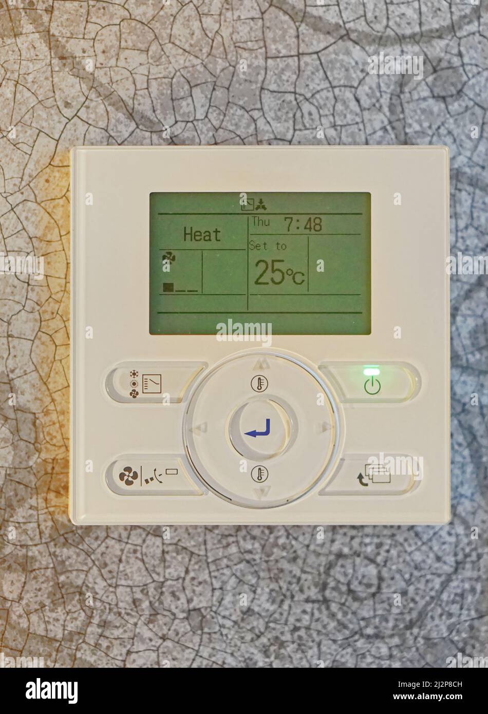 Modern home electronic thermostat heating control at wall Stock Photo