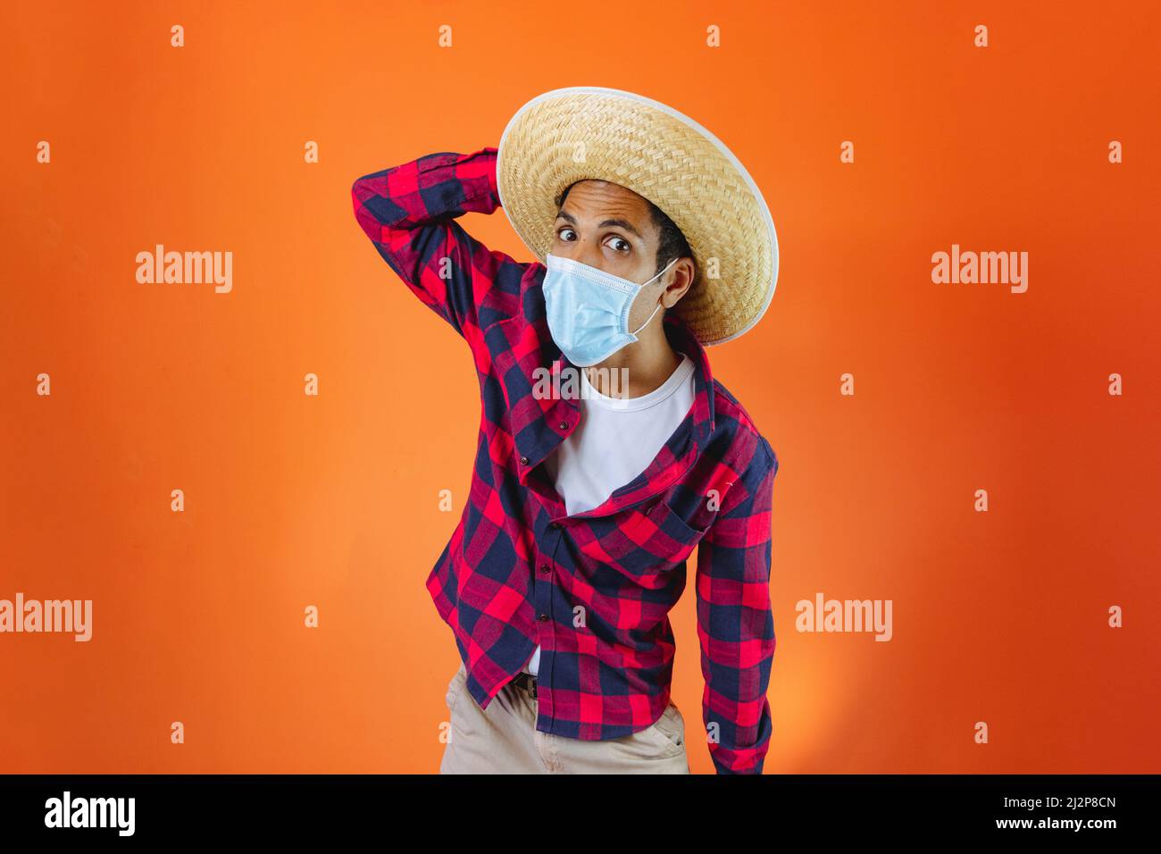 Black Man With Junina Party Outfit and pandemic mask Isolated on Orange  Background. Young man wearing traditional clothes for Festa Junina -  Brazilian Stock Photo - Alamy