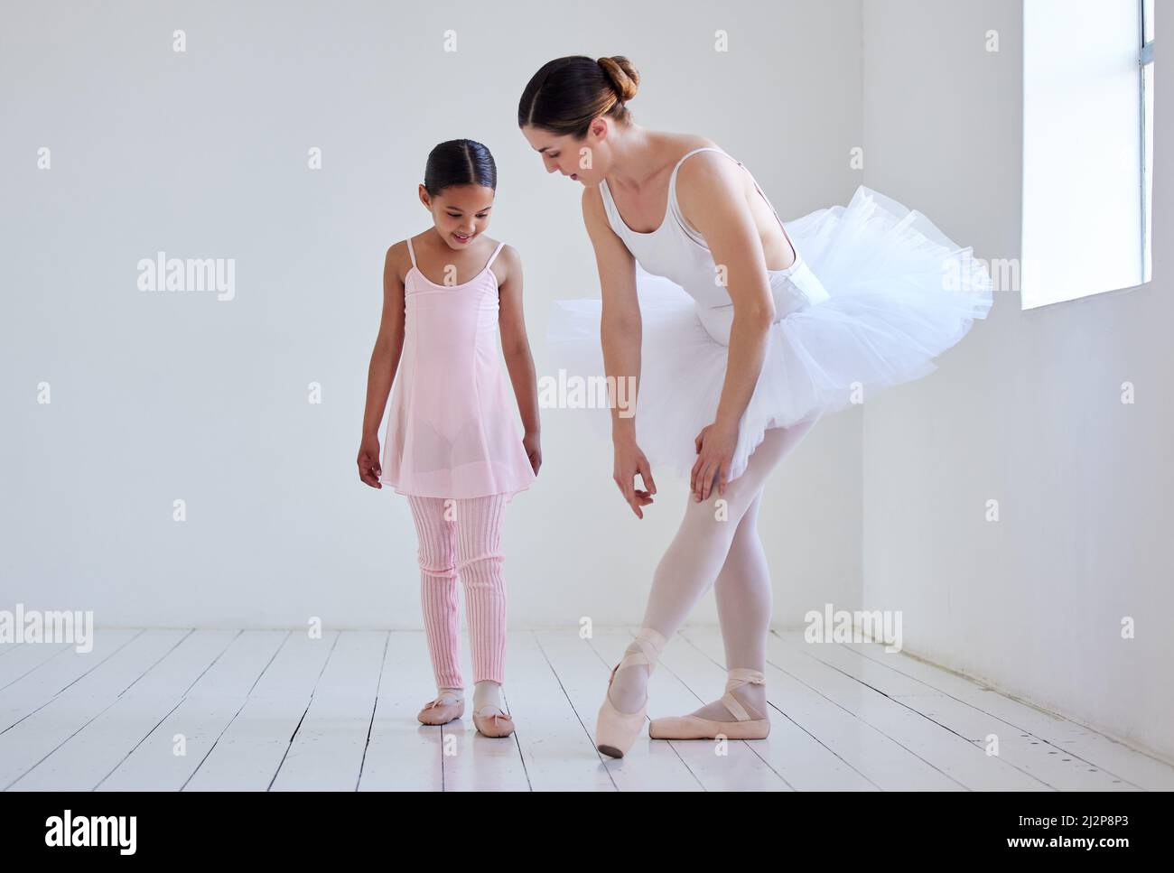 Position your feet like this. Shot of a little girl practicing ballet