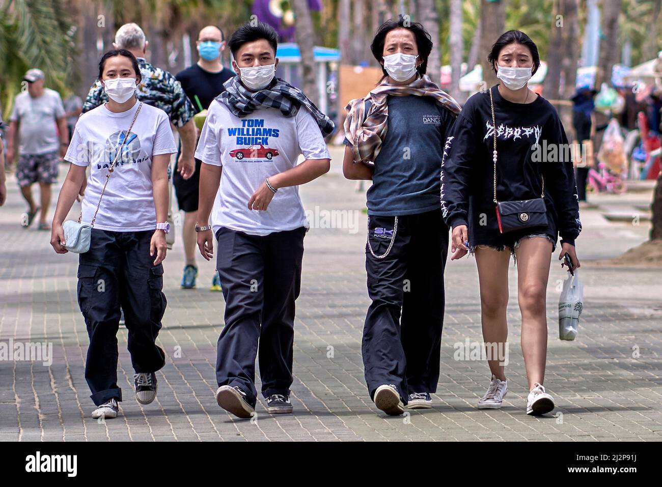 Facemasks people. Couples outdoor walking and all wearing face mask protection against the Covid 19 coronavirus pandemic Stock Photo