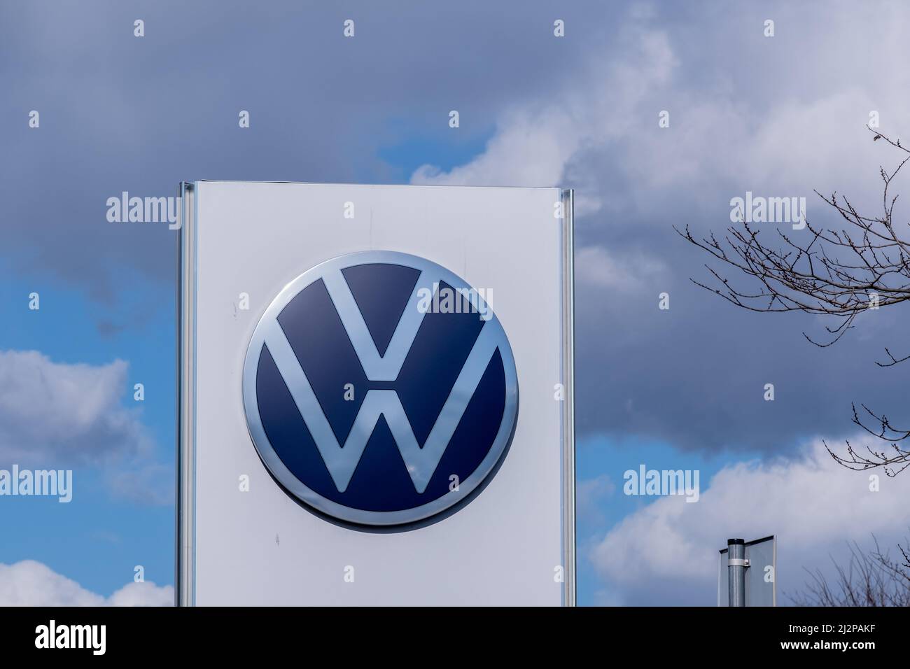 Helsinki / Finland - APRIL 3, 2022: Closeup of a signpost with Volkswagen logo against a bright blue sky Stock Photo