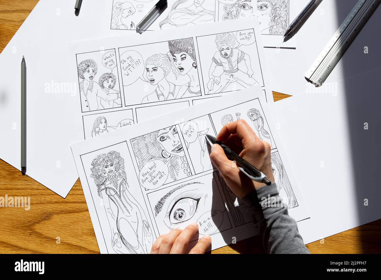 The artist draws frames of comic book characters. An animator designer creates a storyboard. Stock Photo