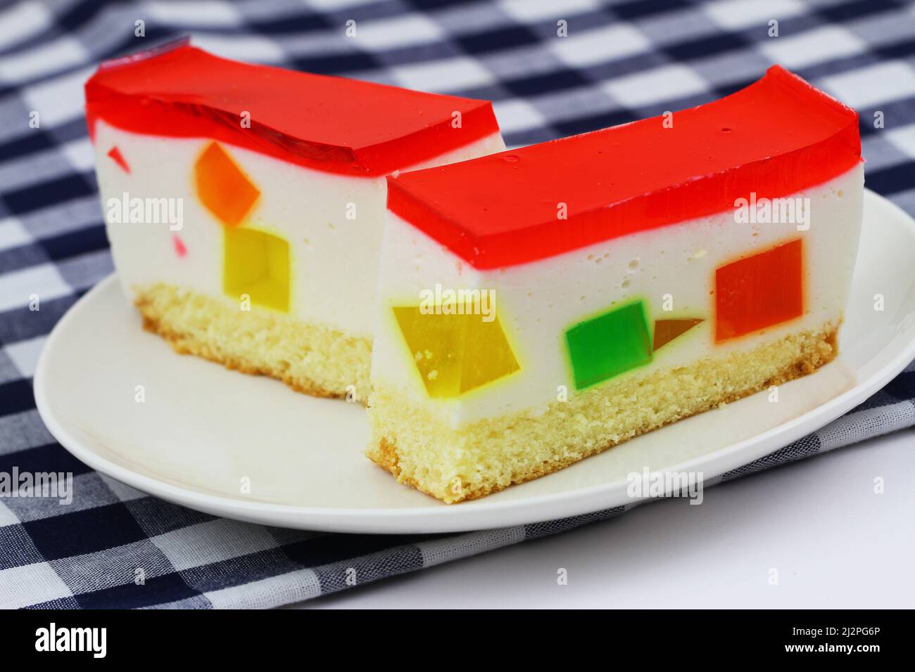 Cheesecake with colorful, fruity jelly pieces, closeup Stock Photo