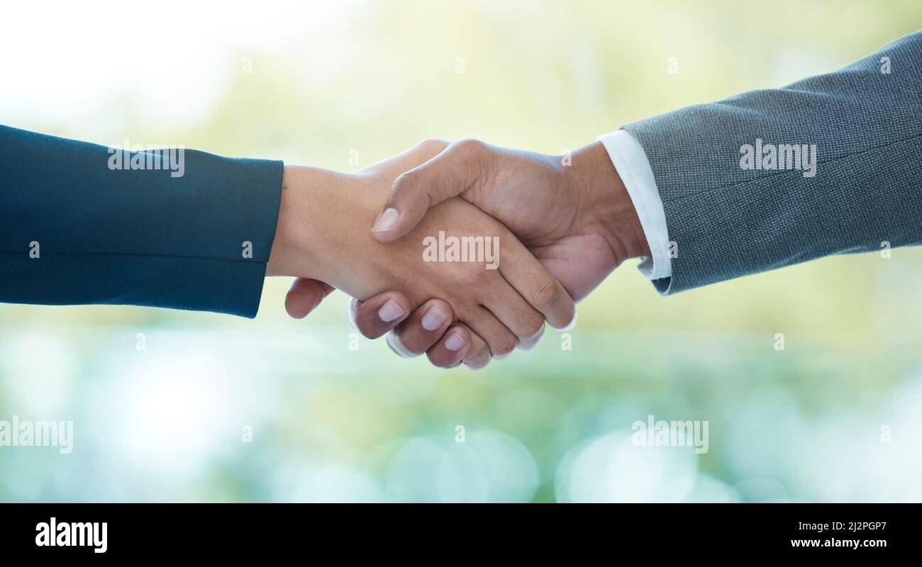 Im glad we could agree on this. Closeup shot of two unrecognisable businesspeople shaking hands in an office. Stock Photo