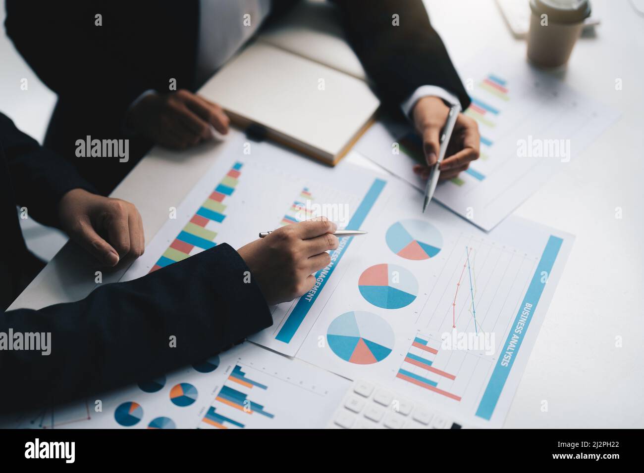 young business team meeting in the office talk about analyses chart graph marketing plan with computer laptop calculator Stock Photo
