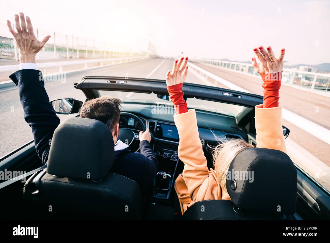 Middle age couple driving a car on road trip Stock Photo