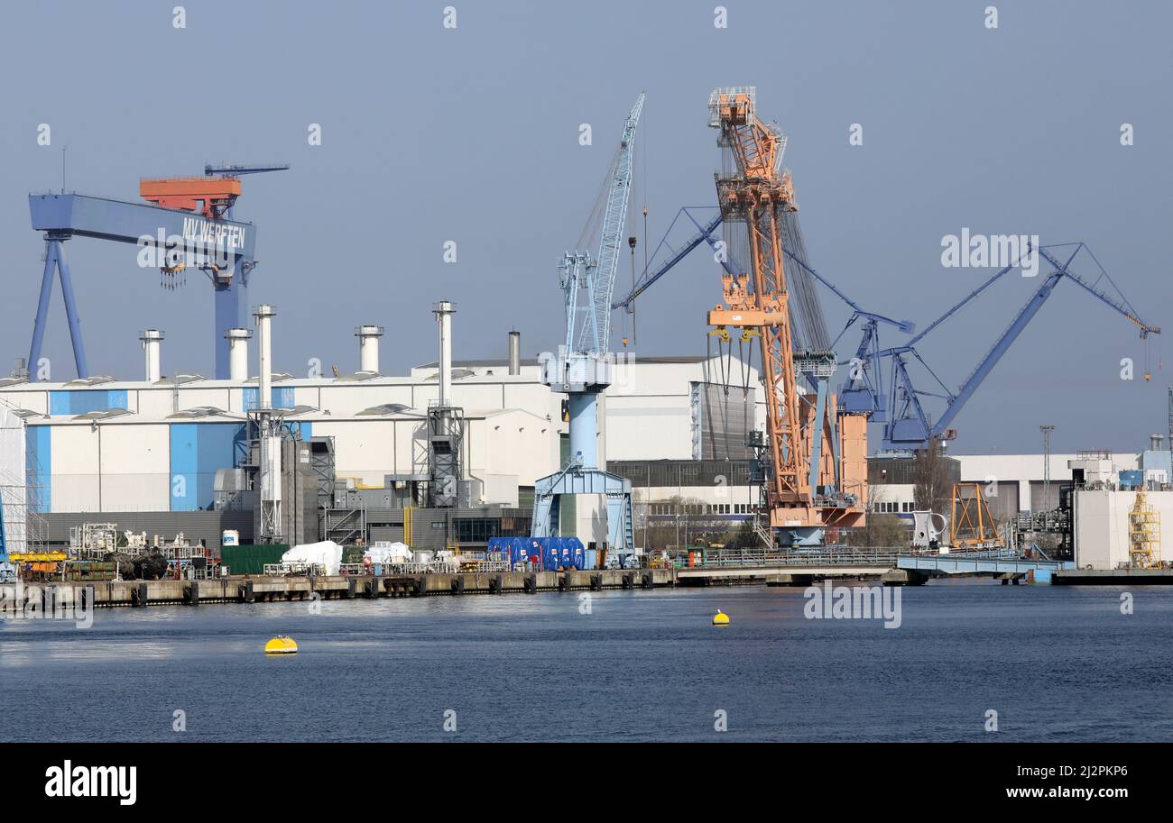 Rostock, Germany. 25th Mar, 2022. The facilities of MV Shipyards (lr), Caterpillar and Neptune