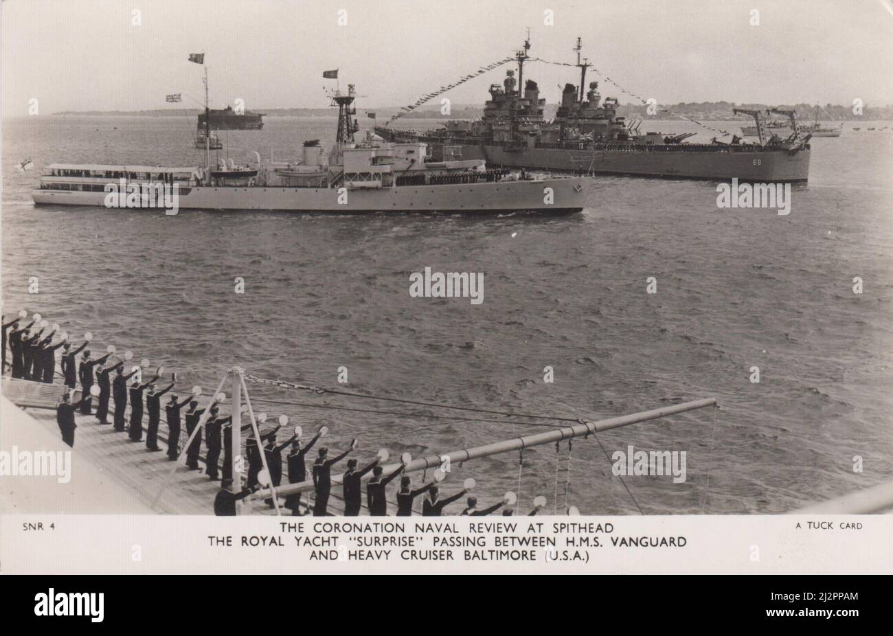 The Coronation Naval Review at Spithead, 1953: The Royal Yacht Surprise passing between HMS Vanguard and Heavy Cruiser Baltimore (USA) Stock Photo