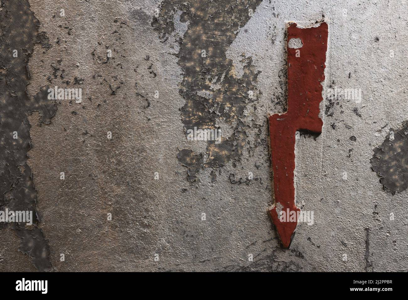 Old electricity sign on a metal surface, close-up view. Stock Photo