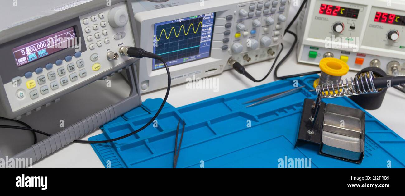 Power supplies and electronic measuring devices in the laboratory.Electronic measuring instruments in science lab. Stock Photo