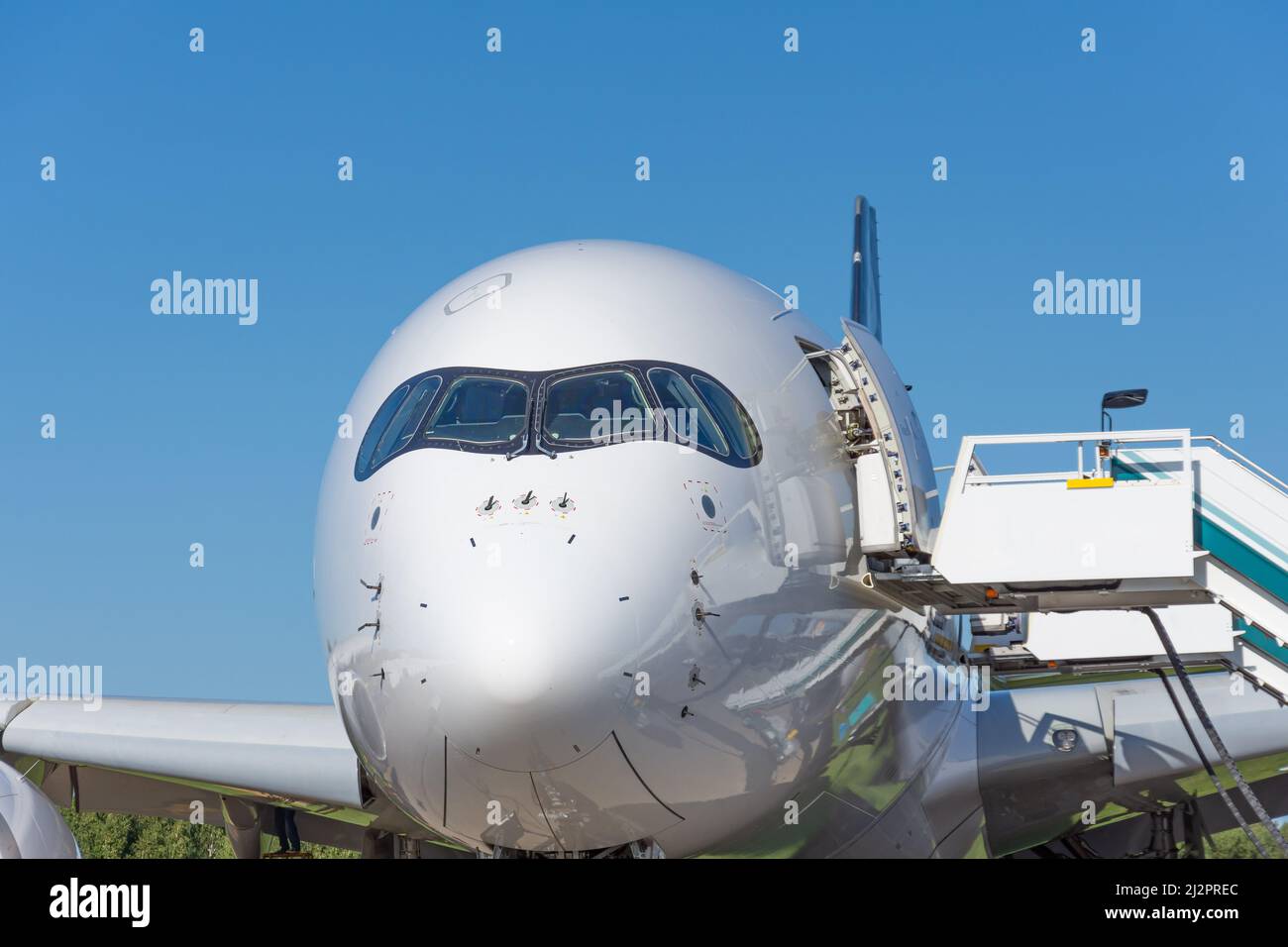 Widebody passenger plane. Aircraft cockpit windshield and nose, with