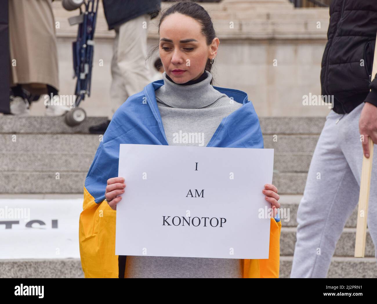 London, UK. 3rd April 2022.  A protester holds a sign which reads 'I am Konotop'. Protesters staged a rally in support of Ukraine in Trafalgar Square and held up signs with the names of Ukraine cities and towns which have suffered the most from Russian attacks. Credit: Vuk Valcic/Alamy Live News Stock Photo