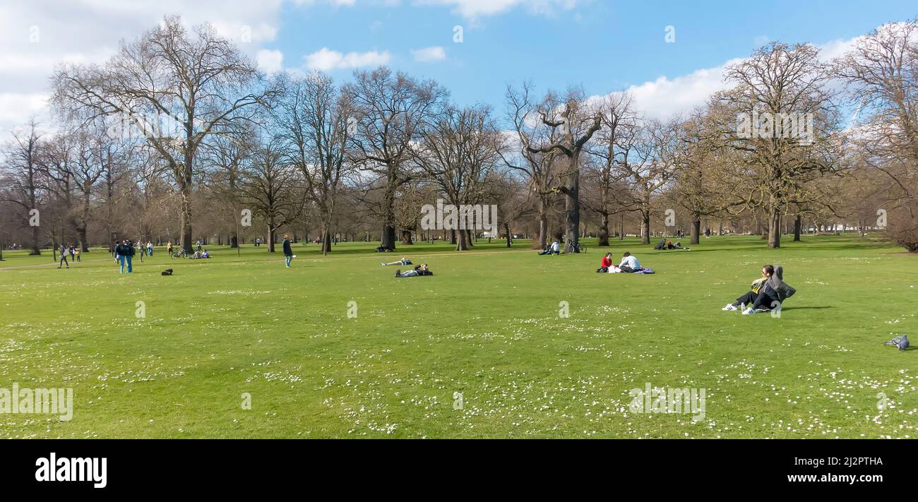 People relaxing in Hyde Park, London in winter/spring Stock Photo