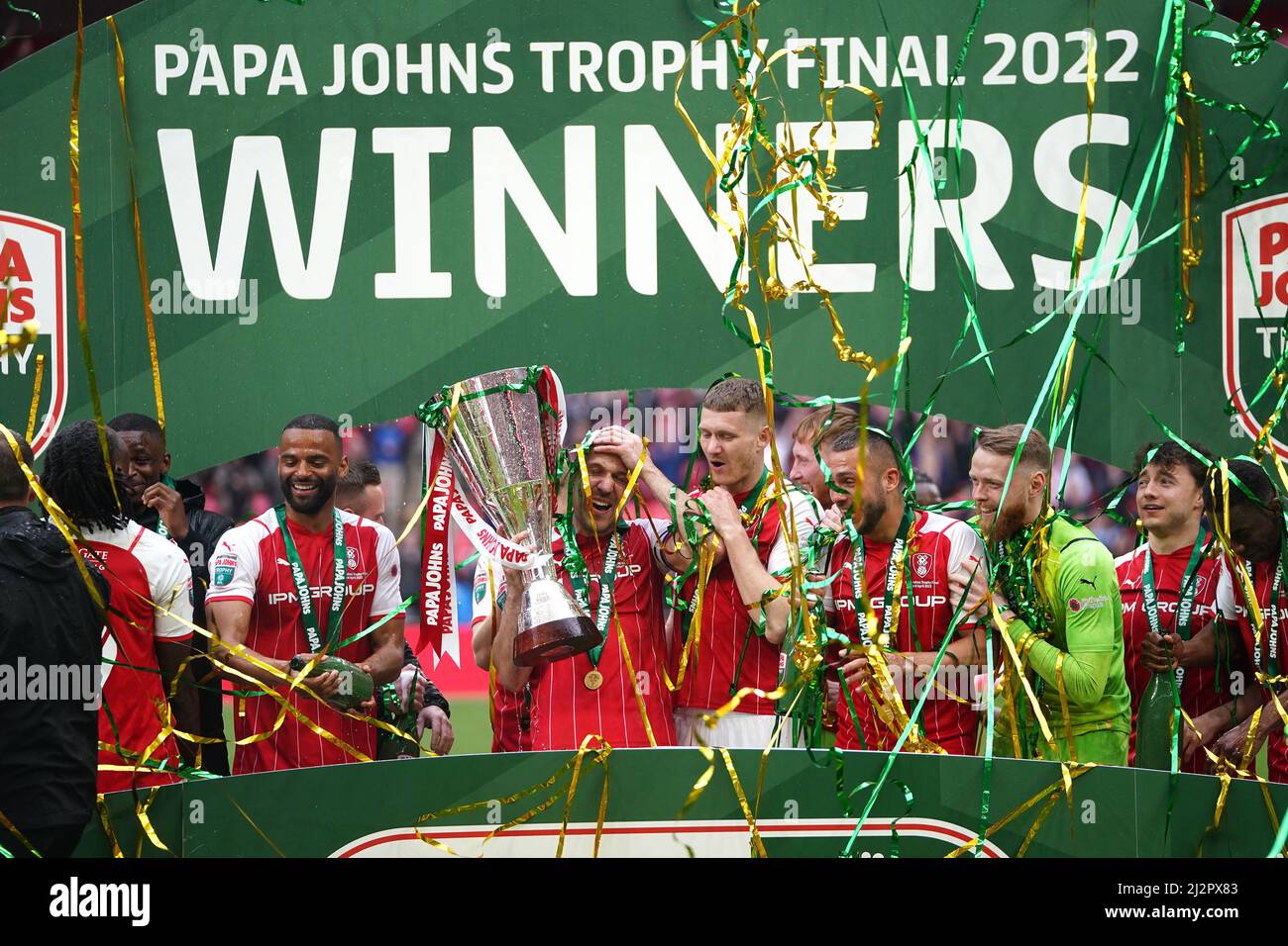 Rotherham United players celebrate on the winners podium with the