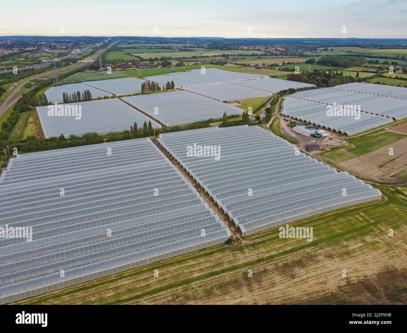 Aerial drone. Plastic greenhouses in Kent, England. Greenhouse plant in the UK. Stock Photo