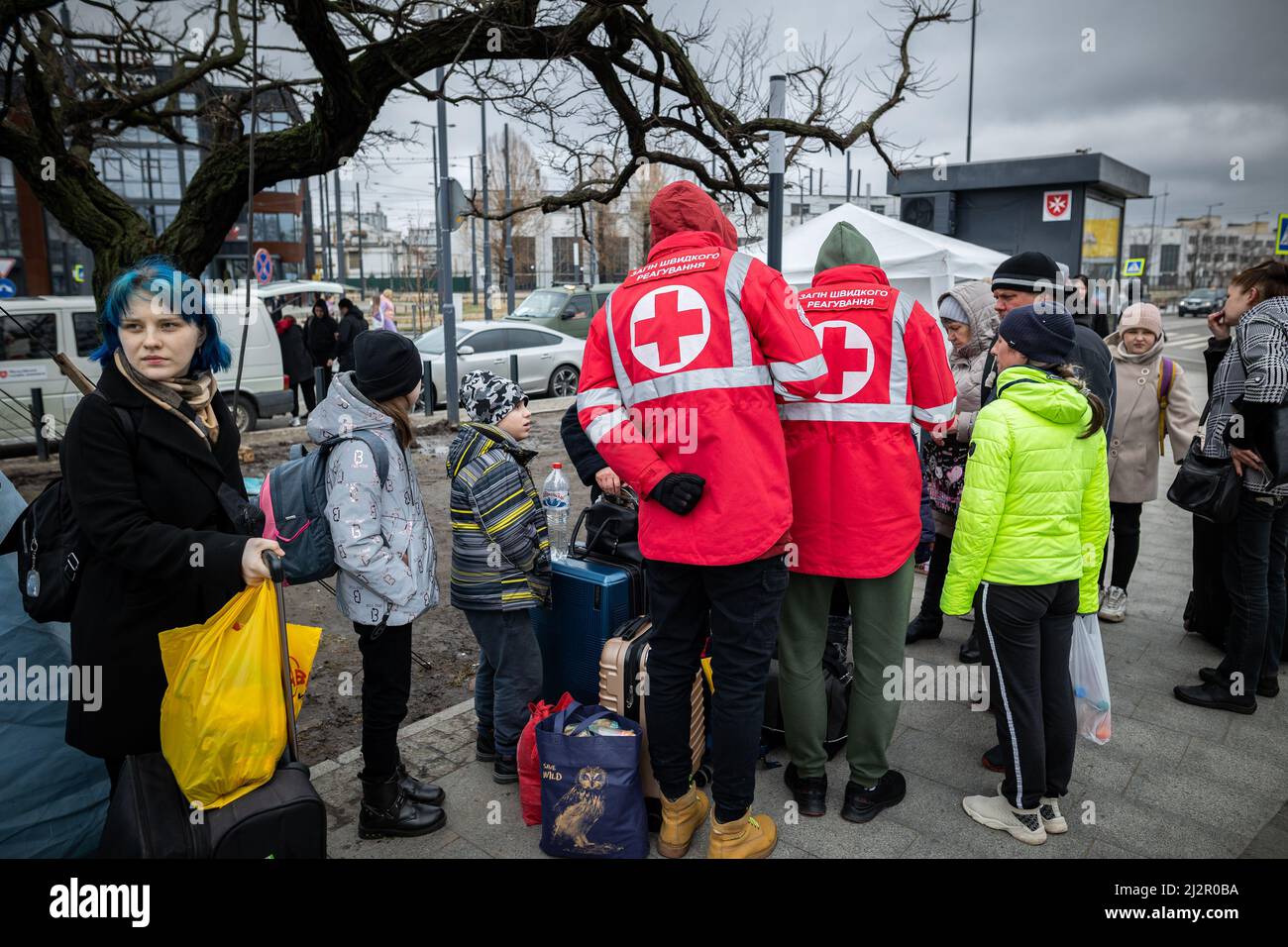 LVIV, UKRAINE - APR 02, 2022: Volunteers in tent camp of World Central Kitchen and Red Cross helping to feed and aid thousands of refugees flee war-to Stock Photo