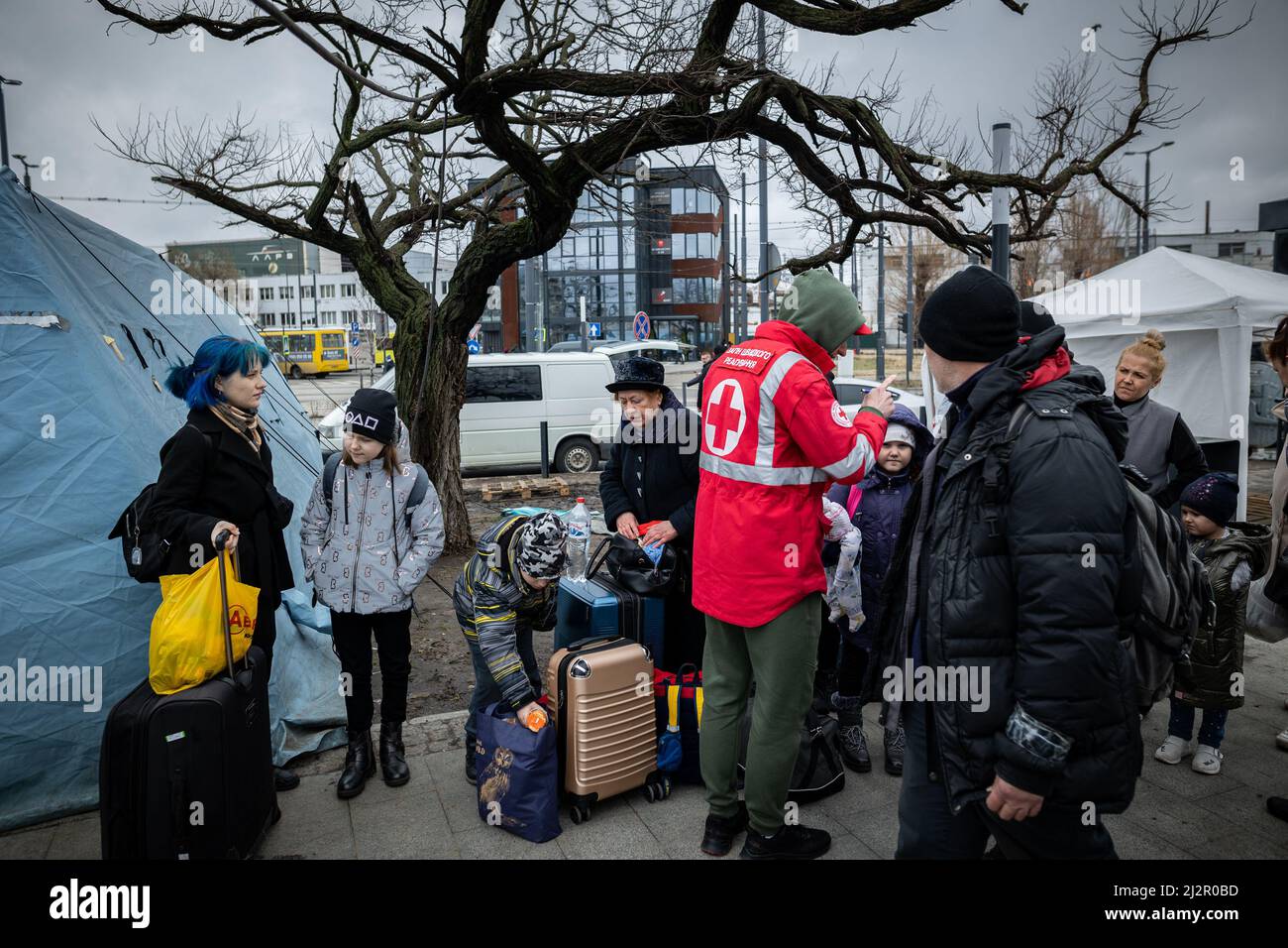LVIV, UKRAINE - APR 02, 2022: Volunteers in tent camp of World Central Kitchen and Red Cross helping to feed and aid thousands of refugees flee war-to Stock Photo