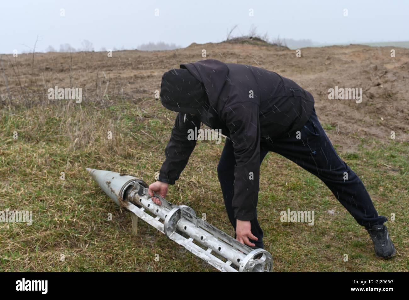 Ukraine. 03rd Apr, 2022. A Ukrainian civilian Gennadiy removes a Russian cluster munition rocket from a field near the villages of Smolyanka and Olyshivka after shelling in the previous nights, in the Chernihiv Oblast on April 3rd, 2022. Olyshivka, Ukraine. Russian military forces entered Ukraine territory on Feb. 24, 2022. (Photo by Justin Yau/Sipa USA) Credit: Sipa USA/Alamy Live News Stock Photo