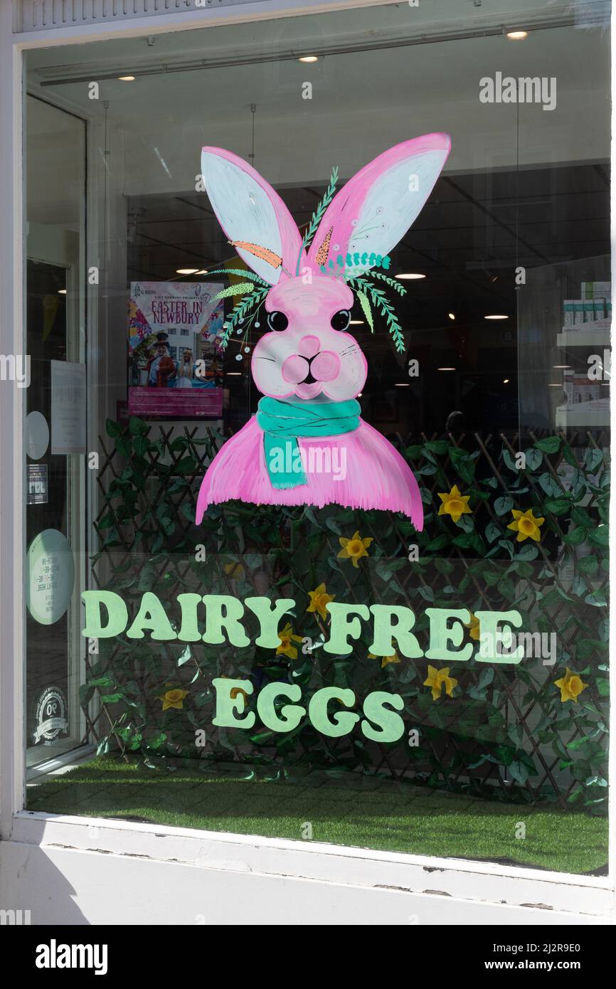 Easter bunny in shop window advertising dairy free eggs, UK Stock Photo