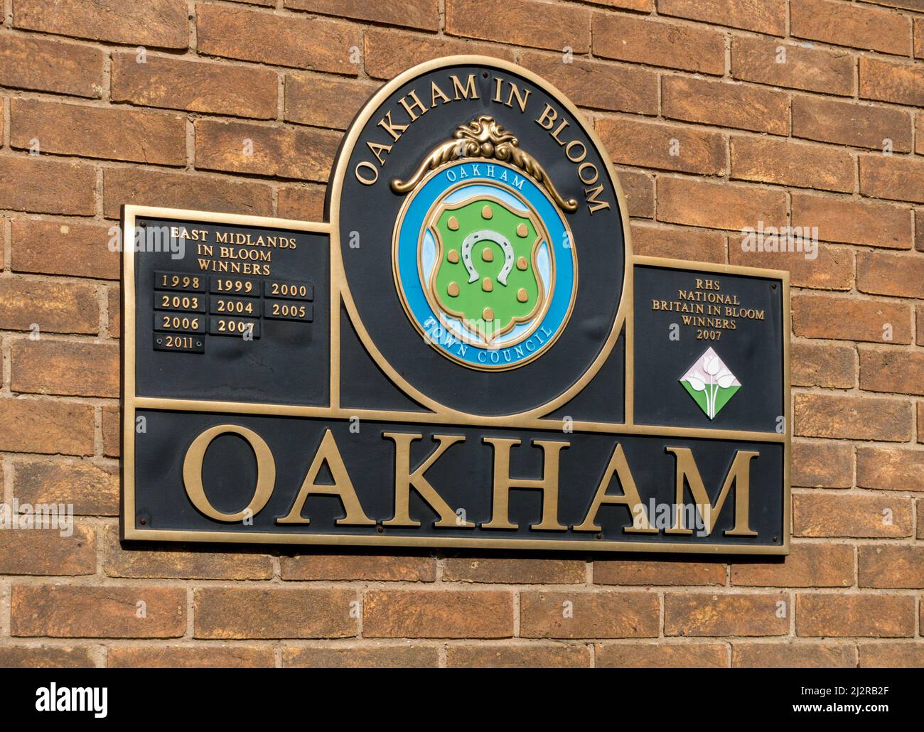 Wall plaque celebrating Oakham in Bloom successes in East Midlands in Bloom & RHS National Britain in Bloom Awards contests, Oakham, Rutland, England Stock Photo