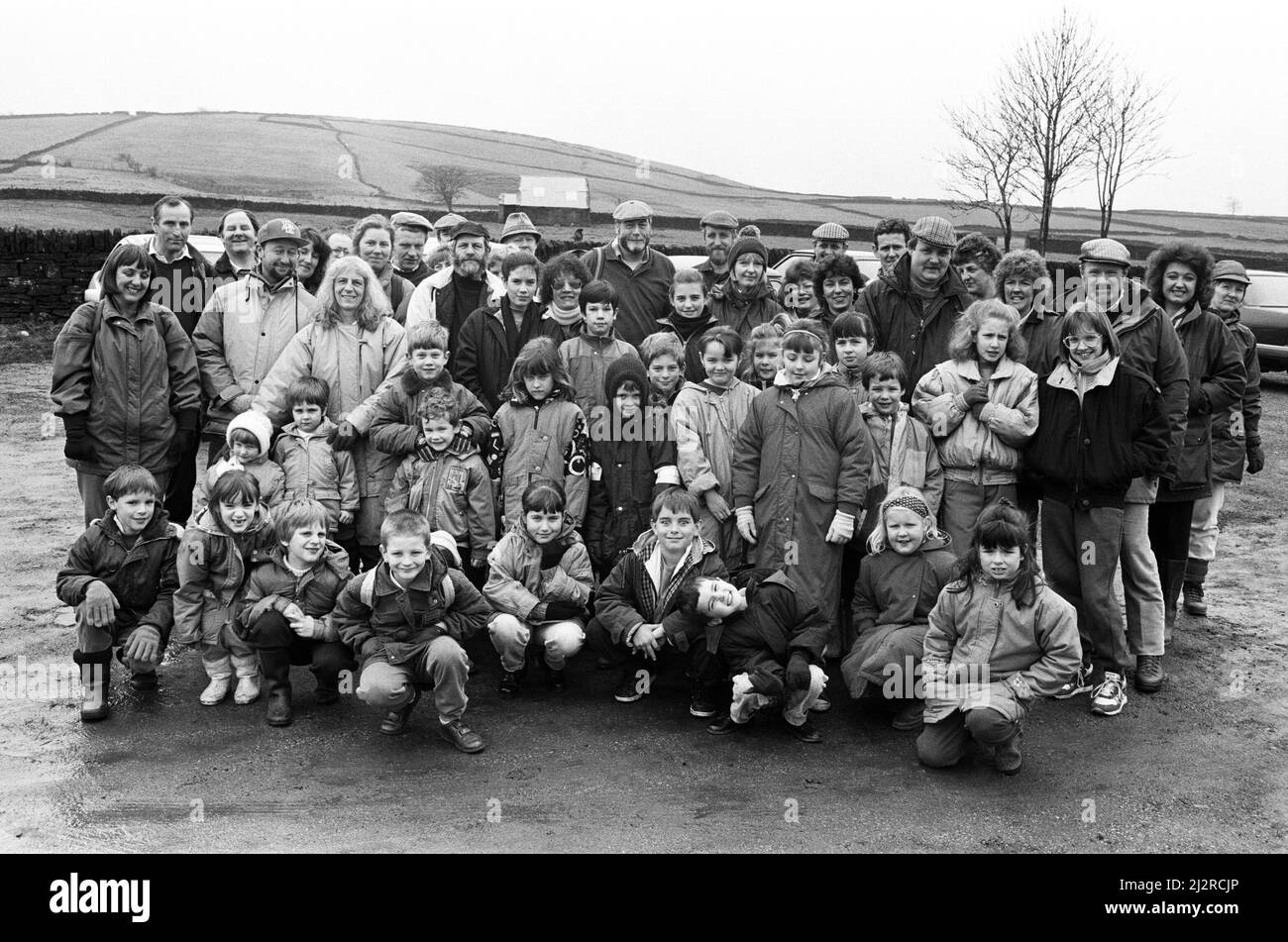 Parent's, teachers and pupils from Newsome Junior School ready to start the Bilberry Walk, a four-mile ramble round Holmfirth based on the tragic flood which swamped the village in 1852, claiming 80 lives. Voluntary countryside officer Nigel Burton lead 61 members of Newsome's School Association on the walk, which included a picnic lunch. The route took them from Bilberry Dam, Digley to the village centre. The continued to Hinchliffe Mill and Perseverance Mill, the sites of numerous deaths when the dam burst it's embankment. 15th March 1992. Stock Photo