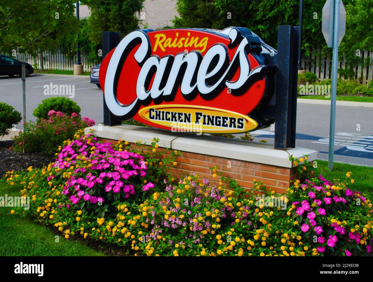 Cane's Chicken Fingers sign surrounded by a flowerbed in Lakewood, Ohio