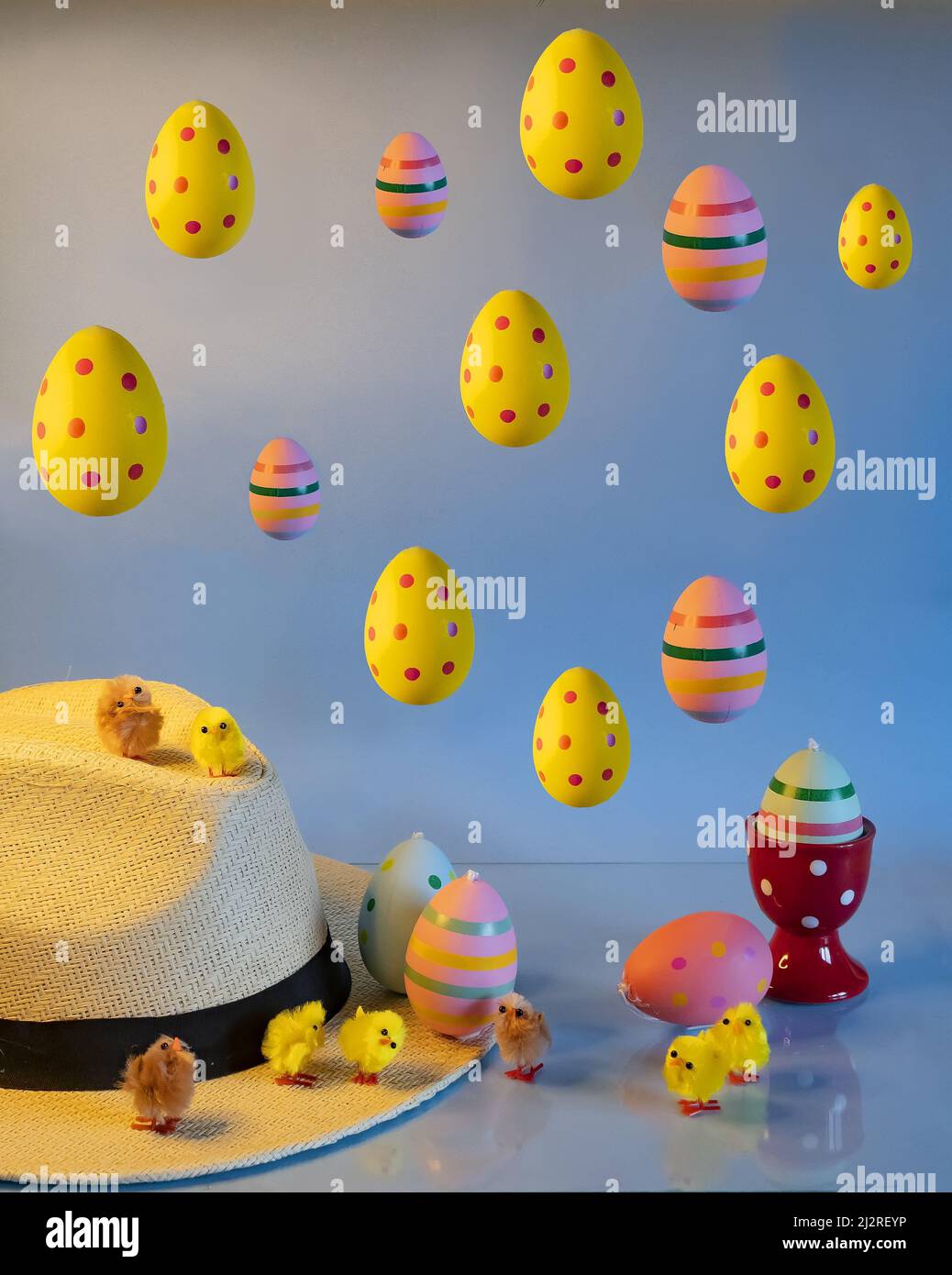 Colorful easter eggs with chicks and straw hat Stock Photo