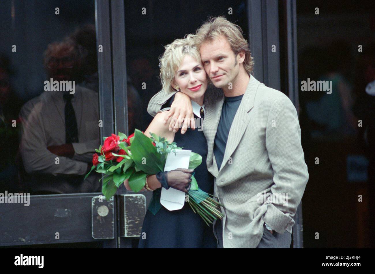 Sting holds and his bride Trudie Styler outside Camden register office, London, after they married in a simple ceremony.  The couple were then blessed in their village church in Great Durnford, Whitshire.  Picture taken 20th August 1992 Stock Photo