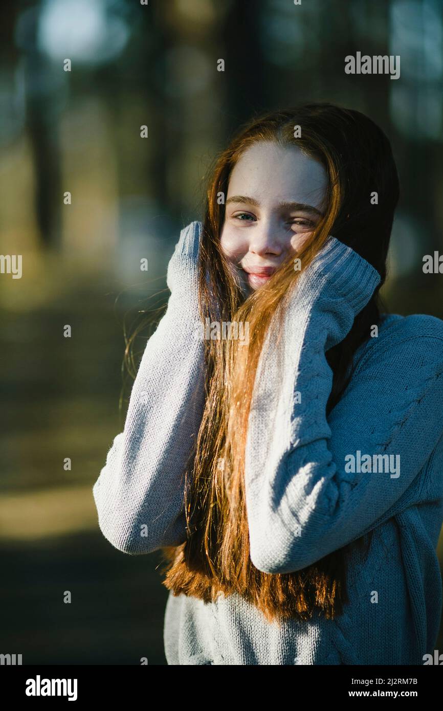 A golden-haired teenage girl in a summer forest. Stock Photo
