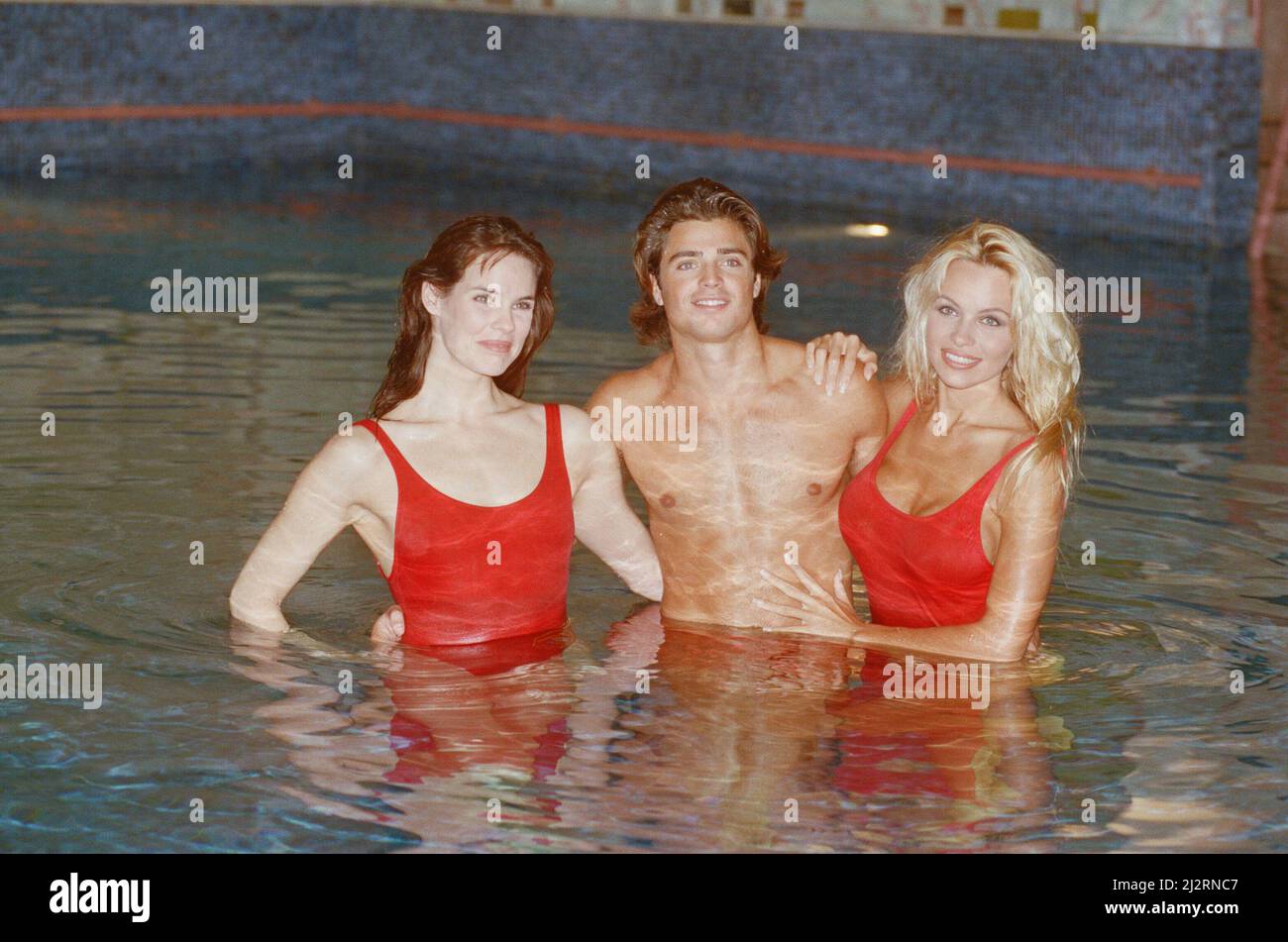 Baywatch stars in a photocall, in London, forthe TV series now appearing on British Television.  Picture shows Pamela Anderson (blonde) Alexandra Paul (brunette) and David Charvet  Picture by Arnold Slater  Picture taken 21st January 1993 Stock Photo