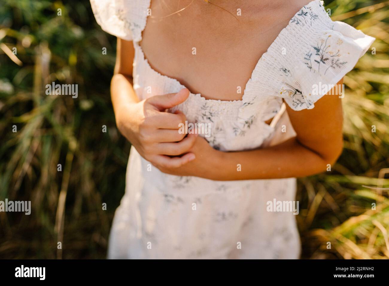 Praying hands of child girl. Photo in the fields Stock Photo