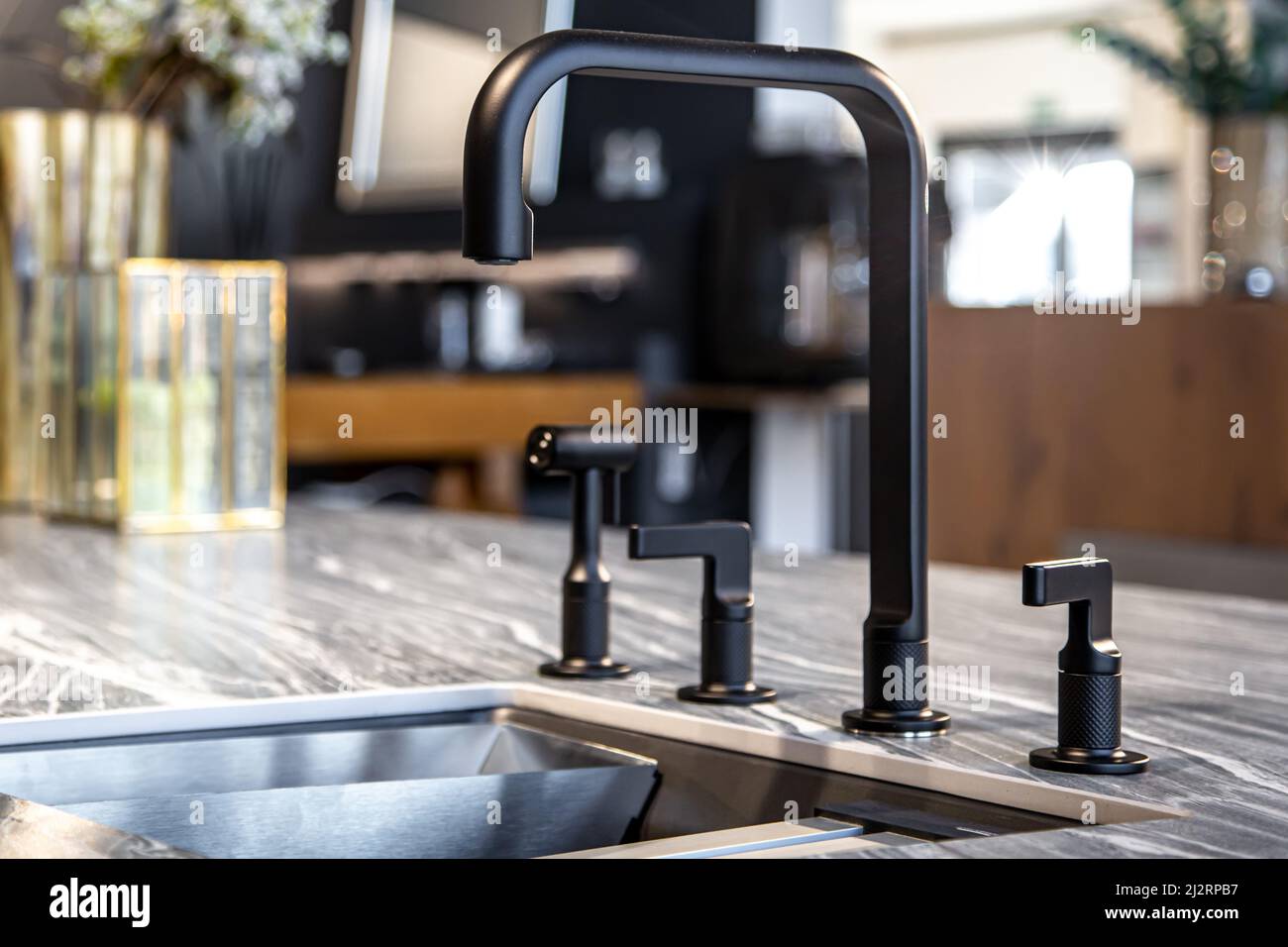 Black faucet with a steel sink in a stylish modern kitchen Stock Photo ...