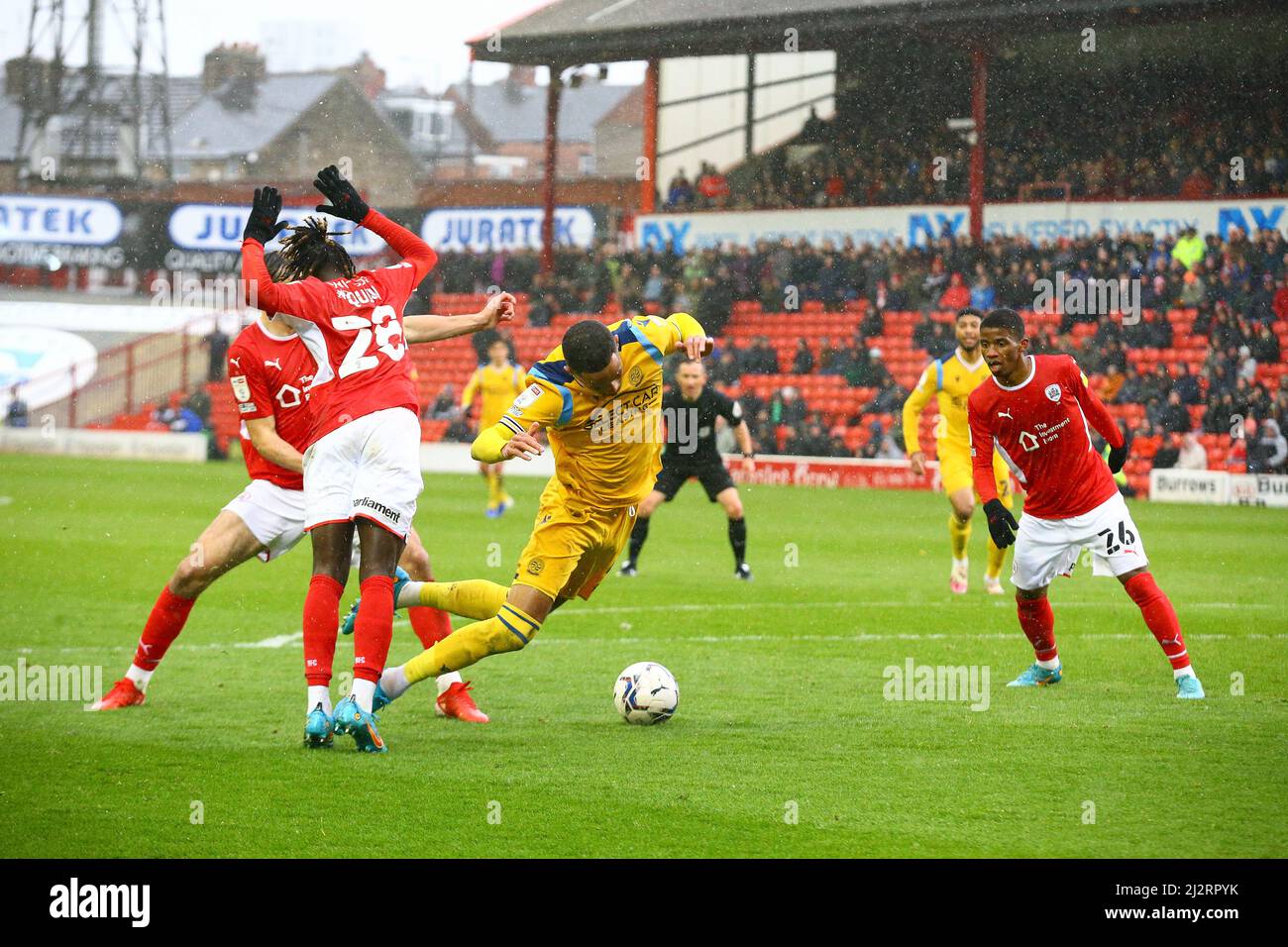 Oakwell, Barnsley, England - 2nd April 2022 Tom Ince (9) of Reading dives in the penalty area after the challenge from Domingos Quina (28) of Barnsley Stock Photo