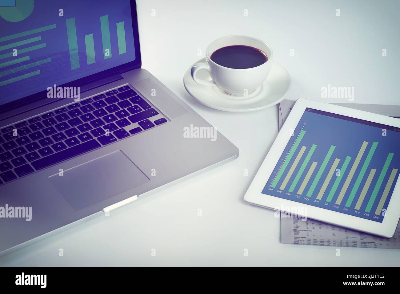 Everything a businessperson needs. Cropped shot of a tablet, a laptop and a cup of coffee on a workstation. Stock Photo