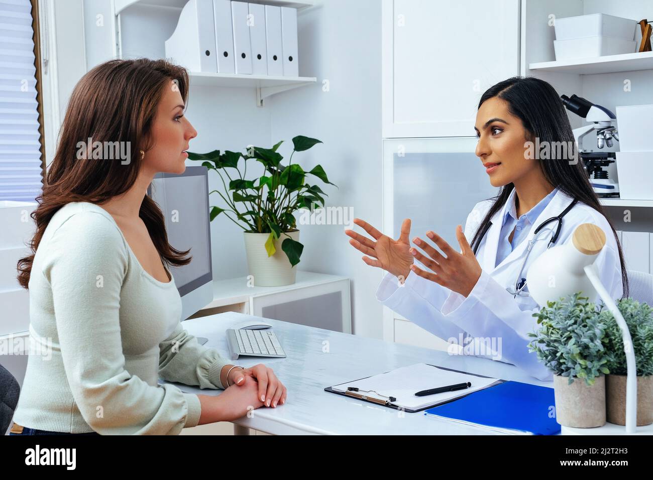 Lady client patient listening to detailed recommendations of qualified specialist at modern clinic medical center healthcare industry Stock Photo