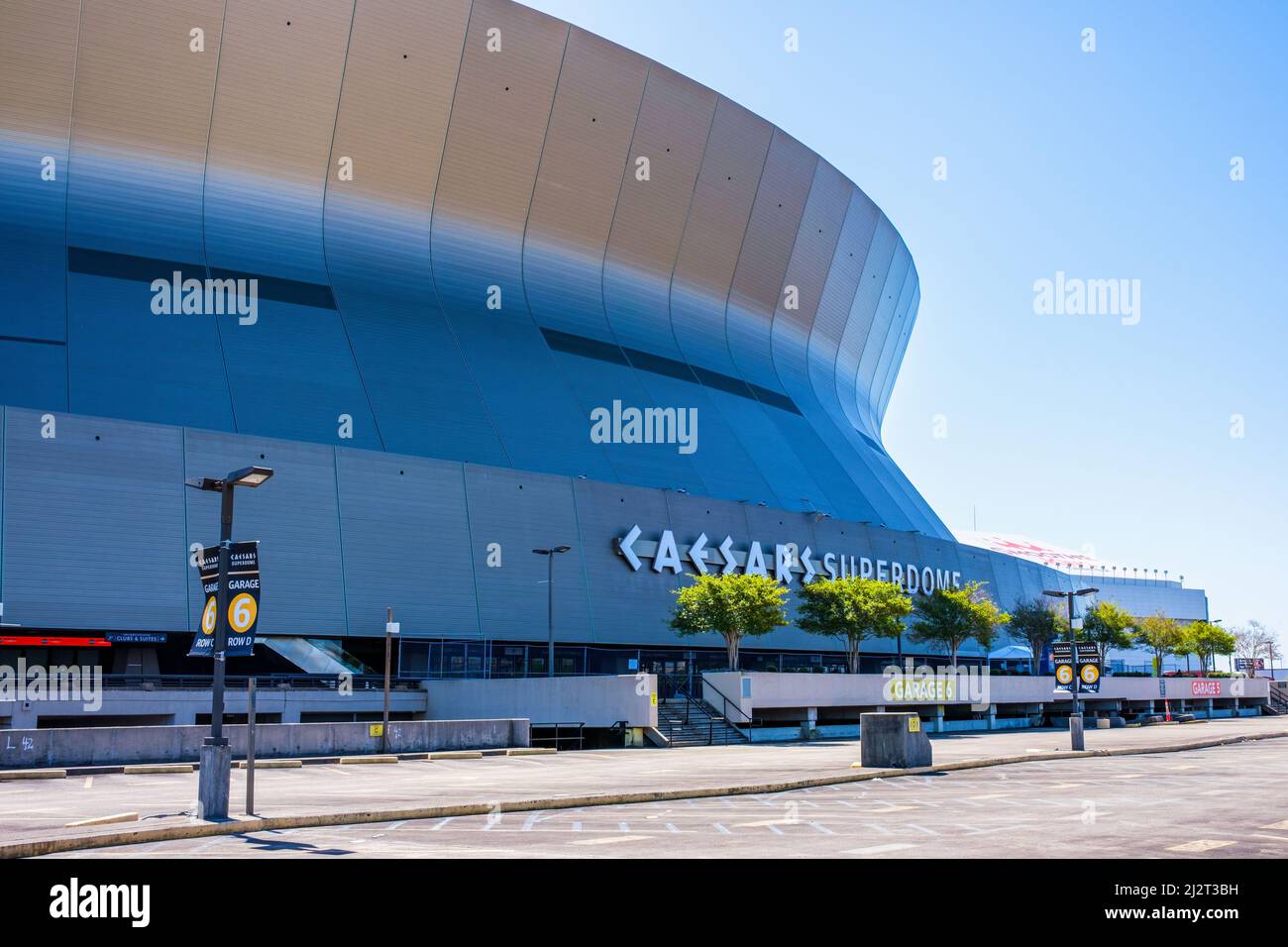 NEW ORLEANS, LA, USA - APRIL 3, 2022: Caesar's Superdome with parking lot and Smoothie King Center in background Stock Photo