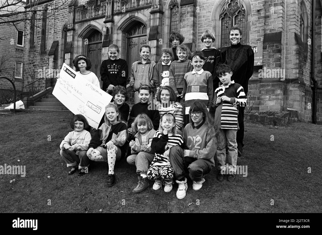 Cheque out... Honley Children's Drama Group, which meets at the village¿ Trinity Church, pictured with the £42 cheque which they presented to the Guide Dogs for the Blind Association. The money was raised at a Christmas Nativity play at the church.  29th February 1992. Stock Photo