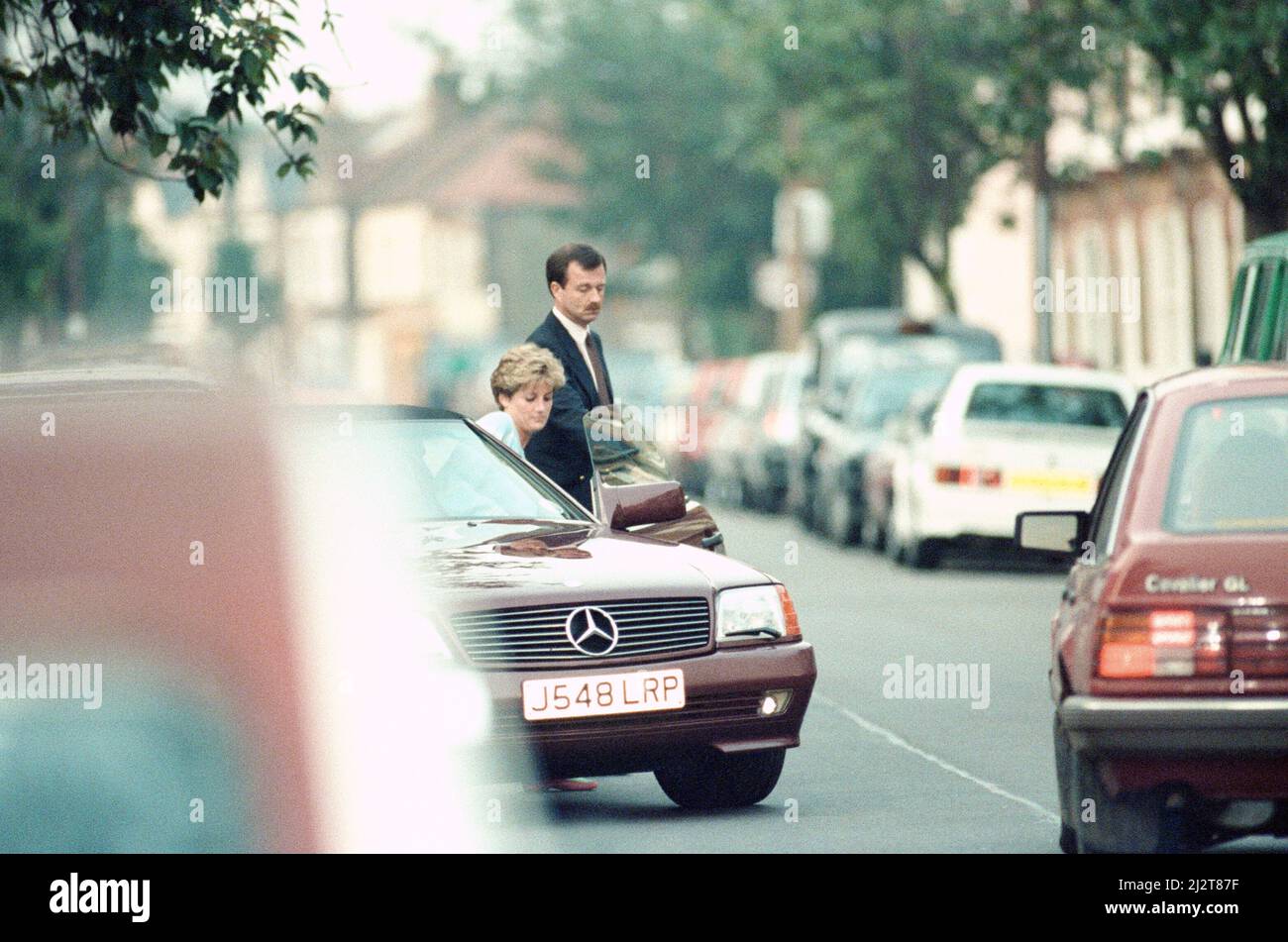 Princess Diana returns to car after visiting friend Carolyn Bartholmew, former flatmate, in London, Wednesday 10th June 1992. Carolyn Bartholmew contributed to a controversial book about Diana's marriage. Carolyn told how Diana suffered from the slimming disease bulimia nervosa and her desperate unhappiness.  But the princess gave her seal of approval to her friend with a kiss. Diana clearly told the world: 'I approve of everything she has done.'   The Press was tipped off so they could witness last night's emotional scene.   Diana spent an hour with Carolyn, her husband William and son Jack. Stock Photo