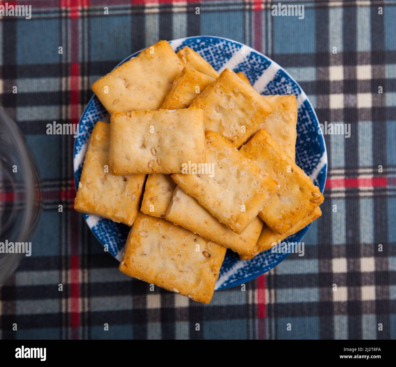 Thin crackers with sesame seeds on plate Stock Photo