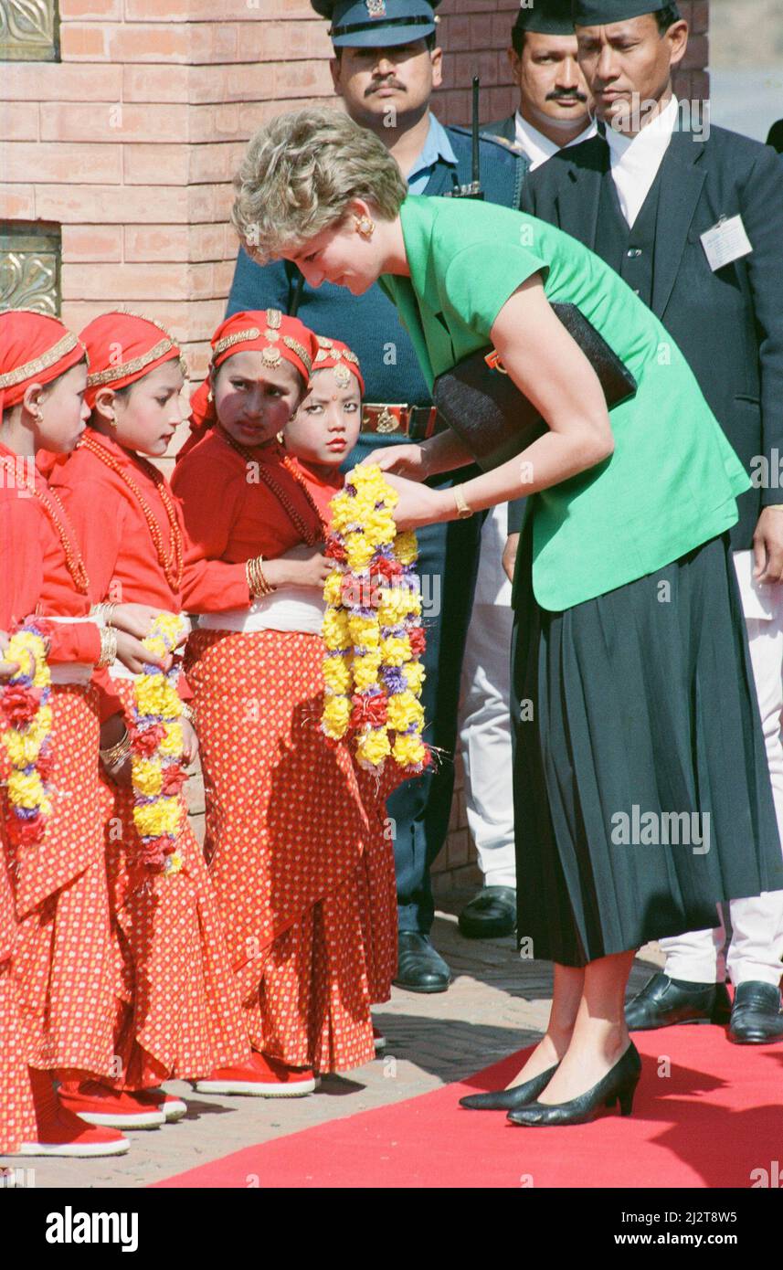 HRH The Princess of Wales, Princess Diana, in Nepal. The Princess visited Nepal between 2nd and the 6th March 1993  Nepal, officially the Federal Democratic Republic of Nepal, is a landlocked central Himalayan country in South Asia. It has a population of 26.4 million and is the 93rd largest country by area.  The Princess receives flowers from the young children as she arrives at Tribhuvan International Airport. Nepal.  Picture taken 2nd March 1993This trip is the first official solo visit abroad since the separation from Prince Charles. Stock Photo
