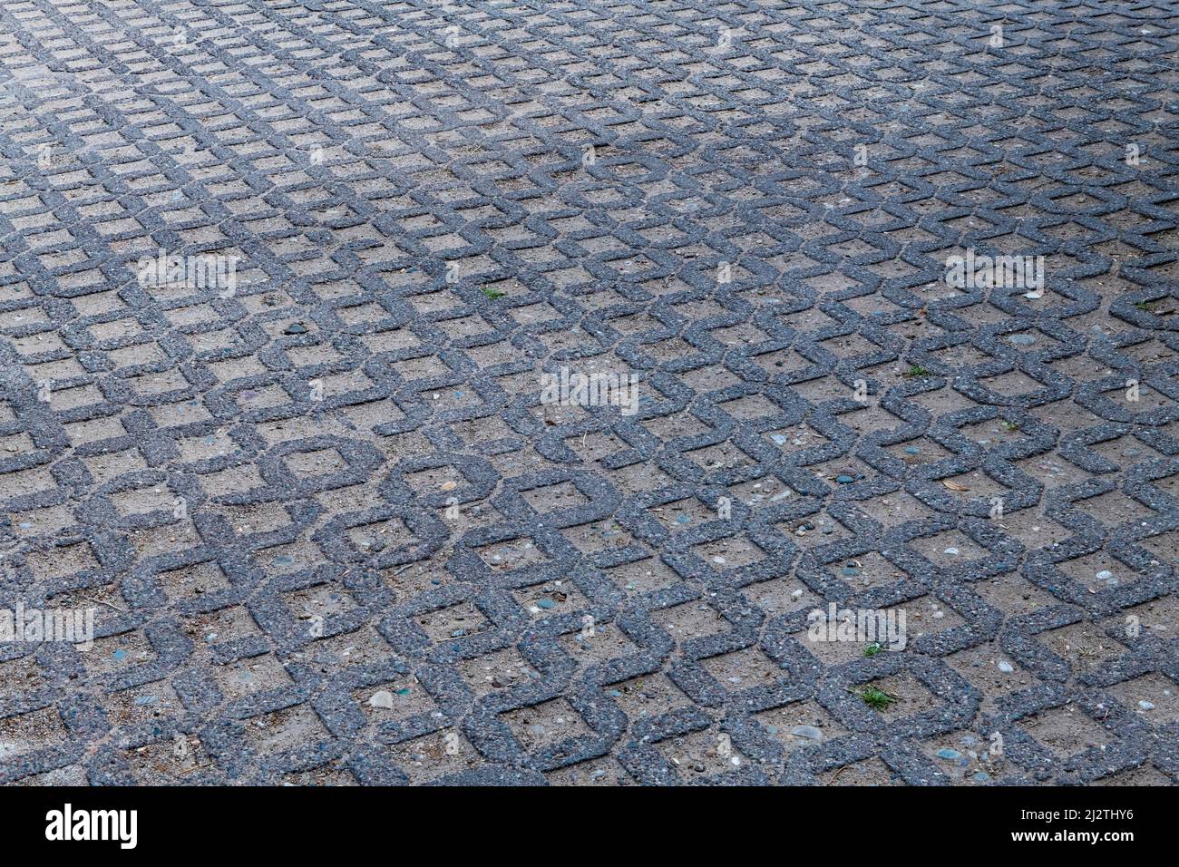 Permeable pavement on a residential city street allows stormwater runoff to filter through surface voids. Stock Photo