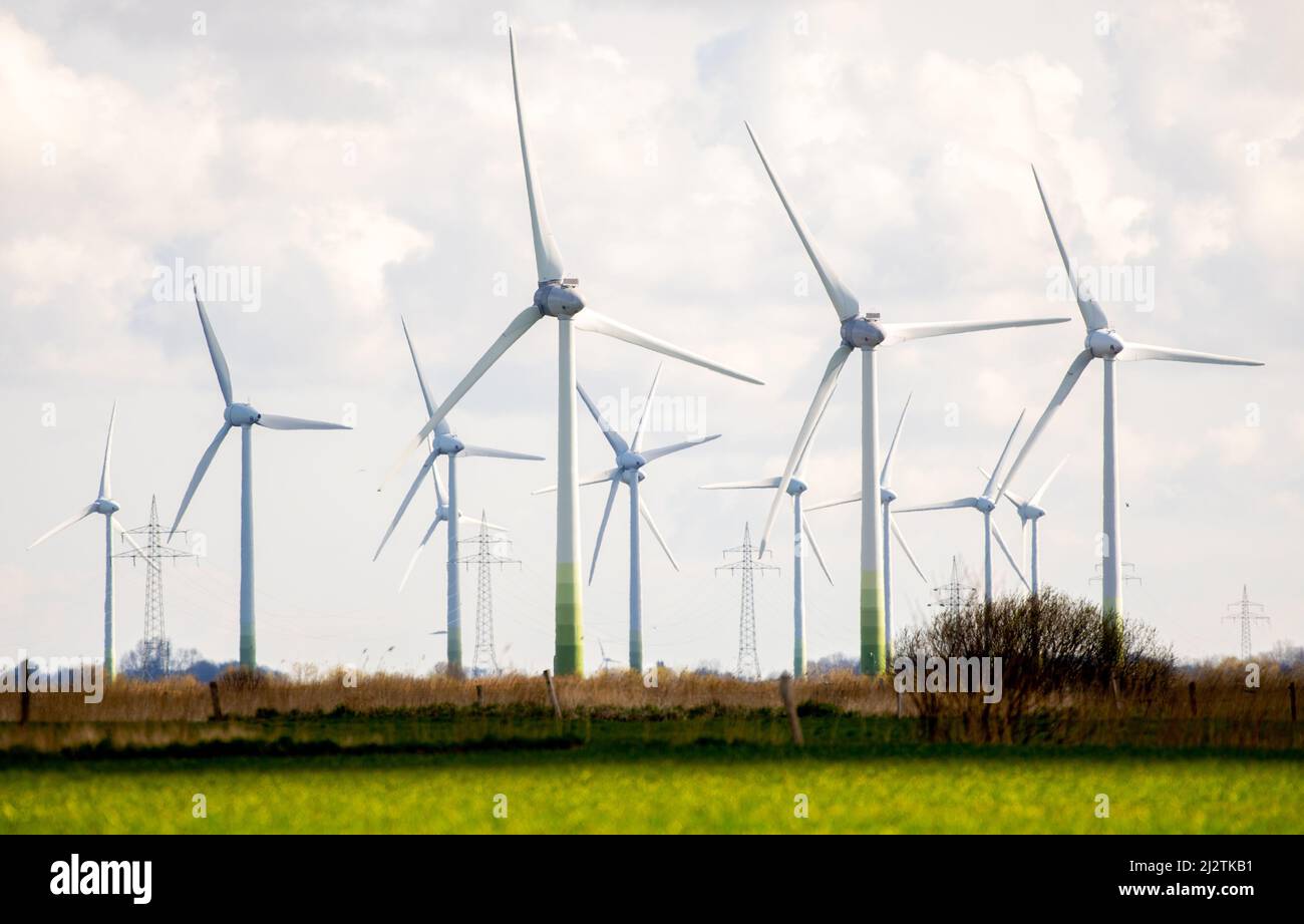 Norden, Germany. 02nd Apr, 2022. Numerous wind turbines are located on fields in the district of Aurich. The Intergovernmental Panel on Climate Change (IPCC) will present the third part of its new assessment report on April 4, 2022. It deals with the political and technological measures to mitigate climate change. Credit: Hauke-Christian Dittrich/dpa/Alamy Live News Stock Photo