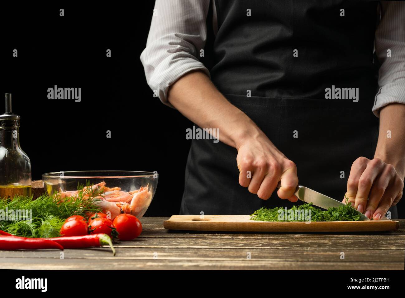 Cook cuts fresh herbal greens hi-res stock photography and images - Alamy