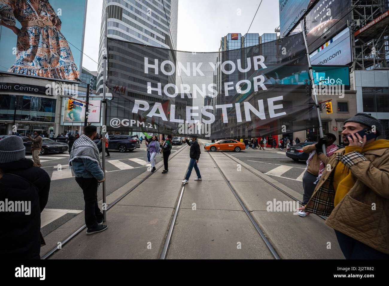 Toronto, Canada. 02nd Apr, 2022. Protestors hold a large "Honk Your