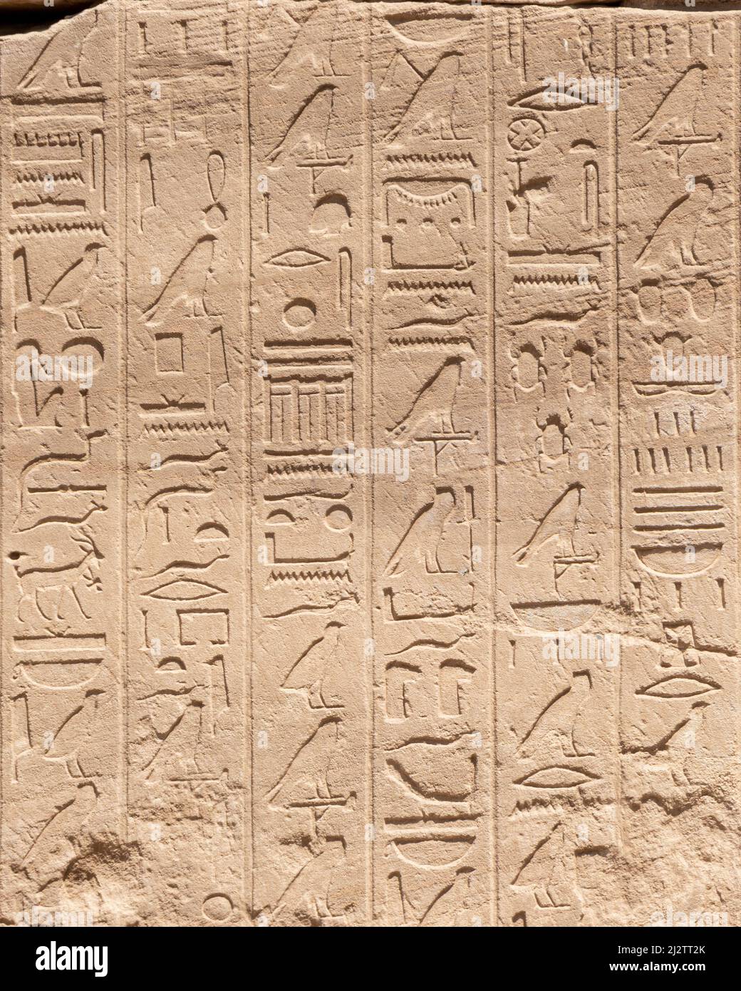 Ancient Egyptian hieroglyphs on the stone walls of the Karnak Temple in ...