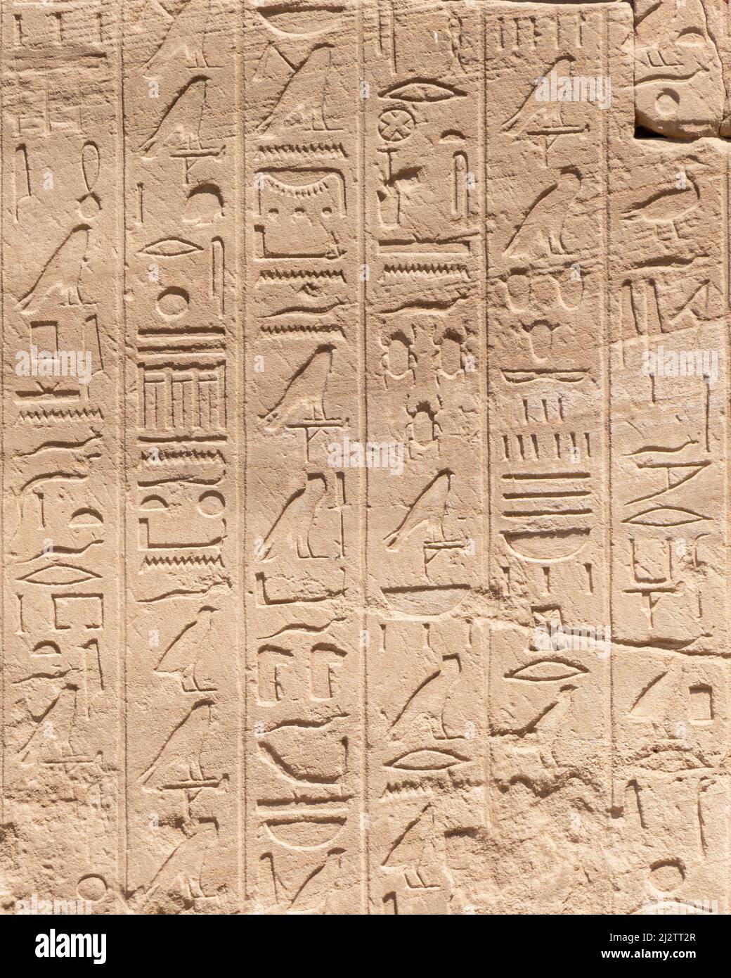 Ancient Egyptian hieroglyphs on the stone walls of the Karnak Temple in ...