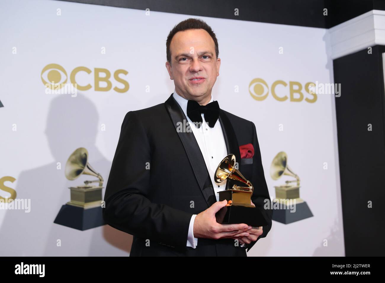 Carlos Rafael Rivera poses with their Grammys for winner of the Best Score Soundtrack for Visual Media award for 'The Queen's Gambit,' at the 64th Annual Grammy Awards at the MGM Grand Garden Arena in Las Vegas, Nevada, U.S., April 3, 2022. Stock Photo
